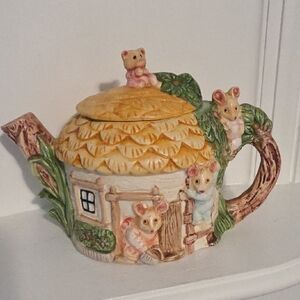 vintage novelty ceramic teapot featuring a cottage and mice design